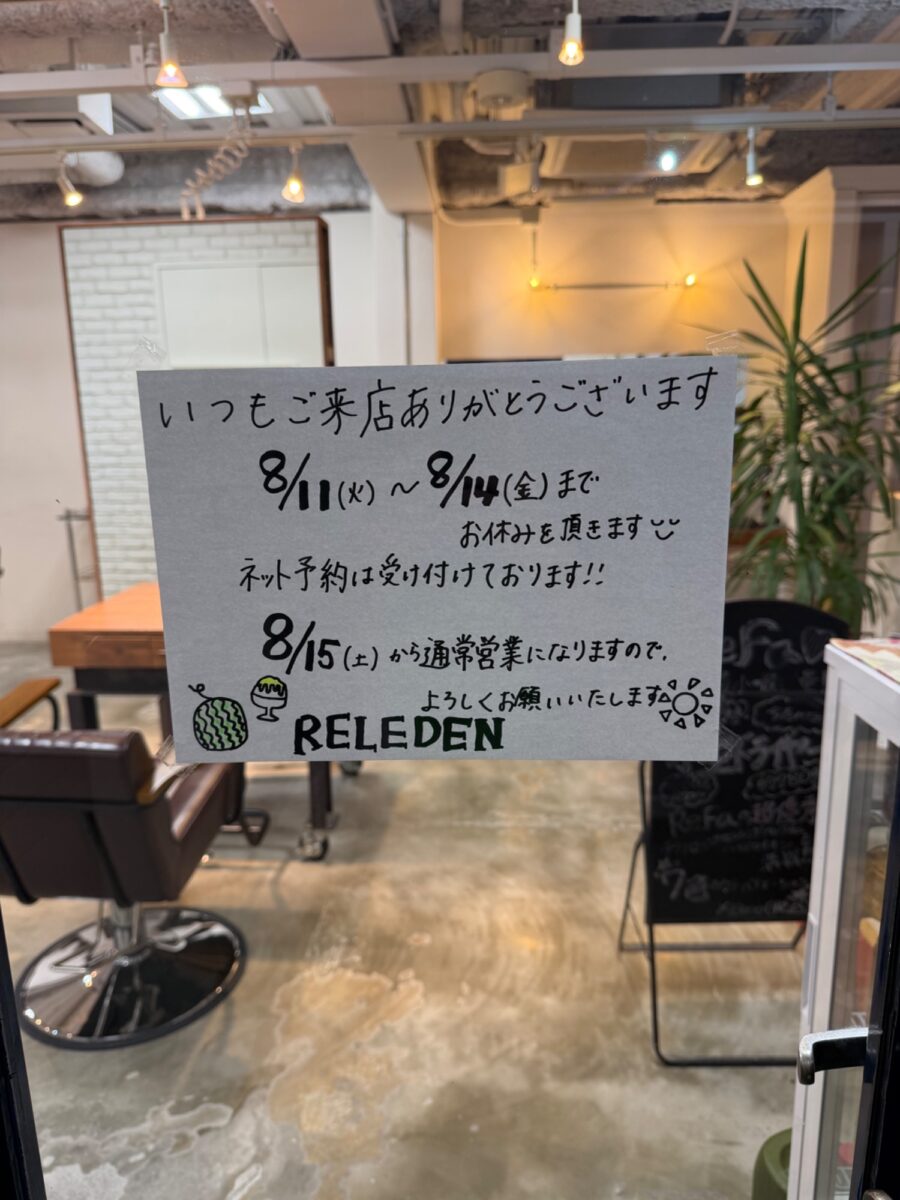 グレーの用紙に手書きされた美容室の夏季休業案内ボード
